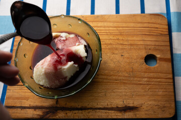 Homemade semolina mousse with sweet wine syrup on wooden board