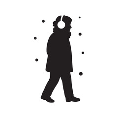 Silhouette of a person with headphones walking in the snow