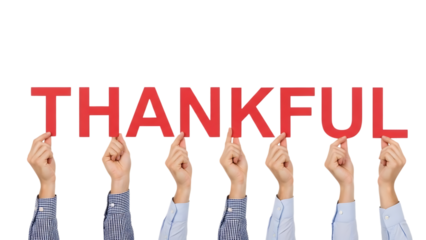 Hands Holding Up the Word thankful Against Black Background