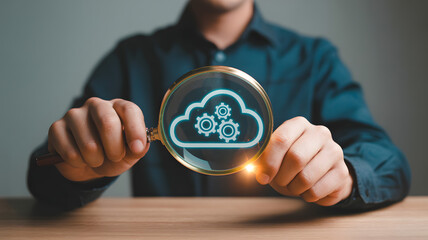 Analyzing Cloud Computing Infrastructure and Automation with Magnifying Glass over Gear Icons.png