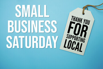 Price tag with "Small Business Saturday " is placed on blue background, symbolizing a limited-time promotional offer