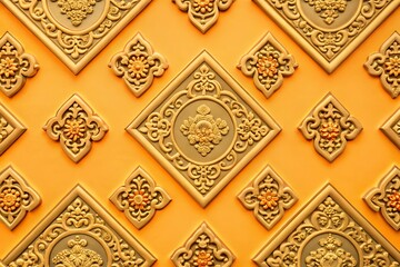 Intricate golden floral patterns on vibrant orange background