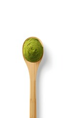 Top view of a wooden spoon filled with green organic matcha powder on white background