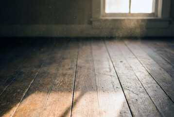 A thoughtful middle-aged man wearing a distressed leather jacket sits by a window on a moving train, looking out at a rainy urban landscape with his reflection visible in the wet glass.