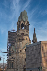 Ku'damm Kaiser Wilhelm Memorial Church - Historic landmark in Berlin, Germany, with modern architecture contrast under a blue sky, representing remembrance and renewal.