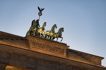 Brandenburg Gate illuminated at twilight - The iconic Brandenburg Gate in Berlin, a symbol of peace and unity, beautifully illuminated against the twilight sky at Pariser Platz, Germany.