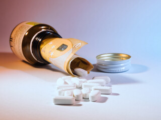 Healthcare Costs: Euro Pills - Fifty Euro bill inside a medicine bottle with yellow pills scattered, illustrating the financial burden and high prices of pharmaceuticals and medical expenses.