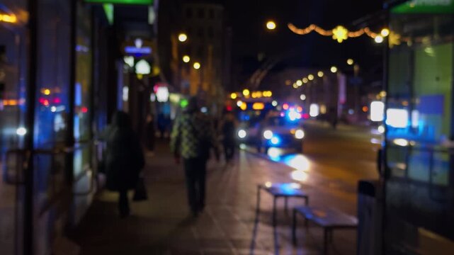 Figure moves past shops on quiet night, Person crossing urban area underneath reflective streetlights