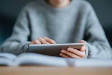Woman comfortably engages with contemporary tablet technology while browsing digital content indoors peacefully.
