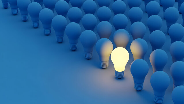 Single glowing yellow light bulb standing out from blue bulbs symbolizing unique idea and business leadership
