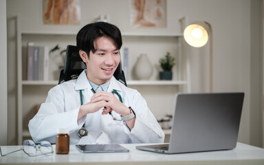 Smiling male doctor conducting an online consultation from his office. Telehealth and digital medical care concept.