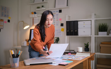 UX UI designer reviewing mobile app wireframes at a modern workspace.