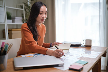 UX UI designer working on mobile app wireframes in a creative workspace.