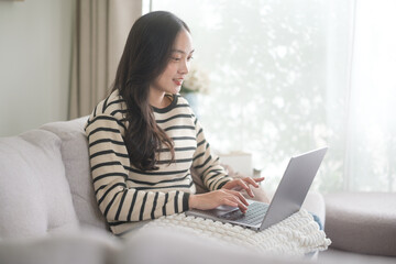 Happy woman browsing or working online at home. Freelance and online communication concept.