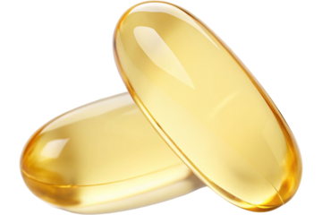 Golden capsules on black background for health and wellness