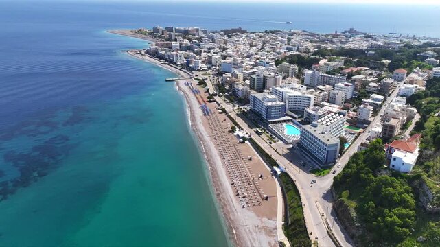 Aerial drone cinematic video of famous main sandy beaches of Rhodes island west coast called Akti Miaouli and Akti Kanari famous for luxury hotels and nice seaside restaurants, Dodecanese, Greece