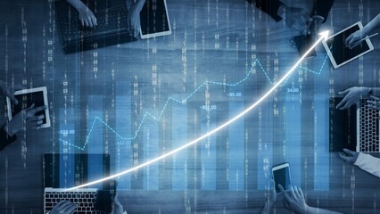 A modern workspace where a team collaborates using laptops and tablets to analyze financial data, showcased with rising graphs and digital overlays for enhanced insights. Copula