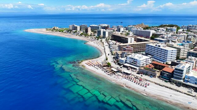 Aerial drone cinematic video of famous main sandy beaches of Rhodes island west coast called Akti Miaouli and Akti Kanari famous for luxury hotels and nice seaside restaurants, Dodecanese, Greece
