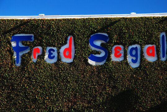 The sign for the Fred Segal retail store on Melrose Avenue in Los Angeles is framed and surrounded by ivy