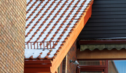 Snow covered tiled rooftops in winter