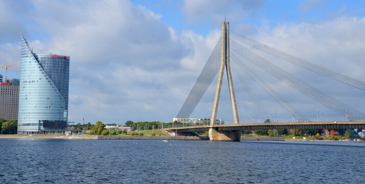 RIGA LATVIA SEPTEMBER 18 2015: The Vansu Bridge in Riga is a cable-stayed bridge that crosses the Daugava river in Riga and Skyline view of left bank, Kipsala island