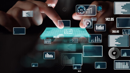 A close-up of hands using a futuristic touchscreen device to engage with vibrant data visualizations, highlighting modern analytics and insightful business performance metrics. Xenic