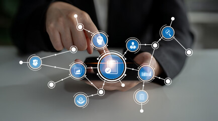 A business professional interacts with a smartphone, showcasing technology icons that represent networking, communication, and data analysis in a modern workspace. Crux