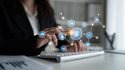 A business professional interacts with technology while ensuring data security using digital symbols in a modern office setting, highlighting connectivity and innovation. Tessel