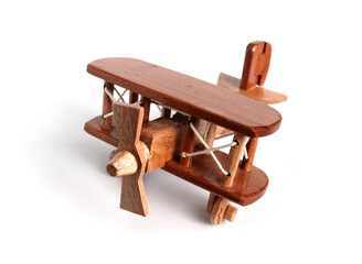 Toy wooden biplane airplane model isolated on white background closeup view © DyMaxFoto