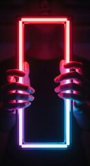 Hands showcasing a vibrant neon rectangular portal against a dark ambiance