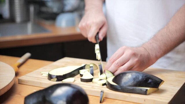Man cutting eggplant