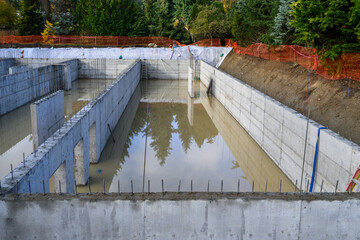 After the storm, under construction stormwater tank flooded with rainwater, foundation dug and...