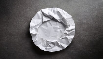 crumpled white circle of paper on textured background