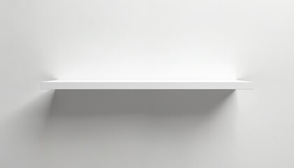 Minimalist white shelf affixed to plain wall surface. Clean modern furniture piece offers empty space for home decor or product display. Simple aesthetic utility.