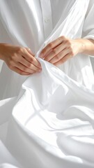 Delicate White Fabric Texture With Soft Natural Light Illuminating Gentle Hands Folding Cloth
