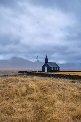 The famous Black Church under moody cloudy sky in Arnarstapi, Iceland