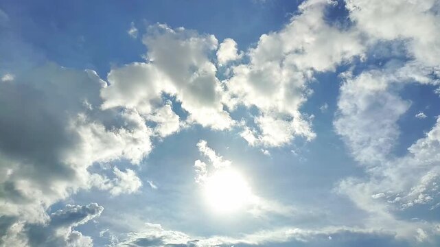 Endless Clouds in the Daytime Sky. A view of clouds and bright sun. Timelapse of the sky and clouds. The sun shines through the clouds against a dramatic sky backdrop.
