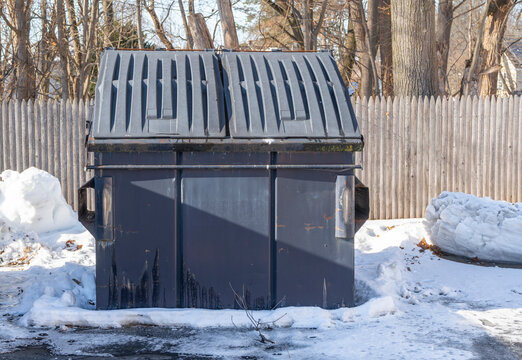 large commercial dumpster outdoor after snow