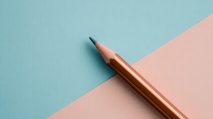 Close up of a Golden Yellow Pencil on a Textured Pastel Blue and Peach Background with Soft Lighting
