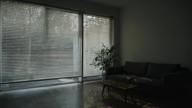 Motorized venetian blinds closing in a modern living room