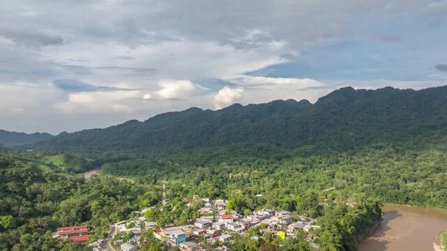 Aerial hyperlapse over Tapijulapa, Pueblo M&aacute;gico in Tabasco, Mexico, revealing lush green mountains, dense vegetation, and the river carving through the tropical landscape.