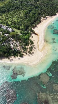 Aerial view of Playa Bonita with leaning palm trees and crystal clear waters, Las Terrenas, Samana.