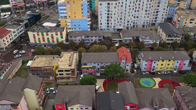 Aerial video of Lezh&euml; with colourful riverside buildings, and dense neighbourhoods below.