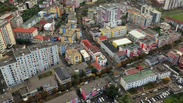 Aerial video of Lezh&euml; with colourful riverside buildings, and dense neighbourhoods below.