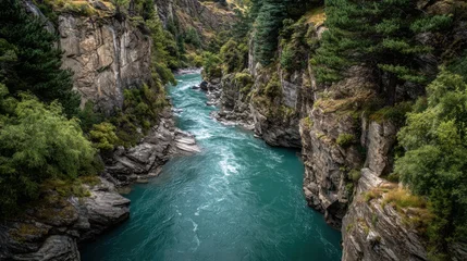 Keuken achterwand Bosrivier Vibrant turquoise river flowing rapidly through a narrow, steep-sided gorge with rocky cliffs and dense green forest  © QBeStock