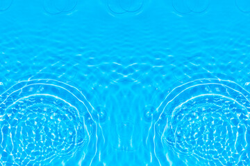 Blue water with ripples on the surface. Defocus blurred transparent blue colored clear calm water surface texture with splashes and bubbles. Water waves with shining pattern texture background.