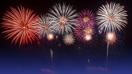 Vibrant fireworks exploding in the night sky with colorful bursts of light and energy