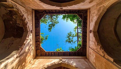 View of Bright Blue Sky Through Ancient Stone Ceiling Opening at Historical Site