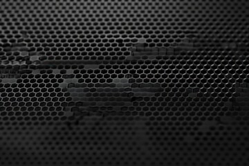 Close-up of black hexagonal grid pattern with smooth wave-like distortions creating a textured and abstract surface