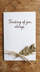 Rustic Handmade Thinking of You Card with a Dried Botanical Element, Conveying Comfort and Unwavering Remembrance, Placed on a Warm Wooden Background